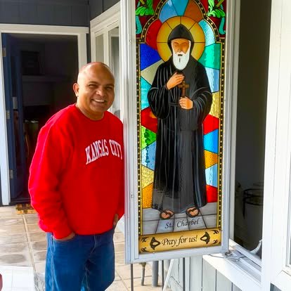 Un membre de la communauté près d’un vitrail de saint Jean Eudes